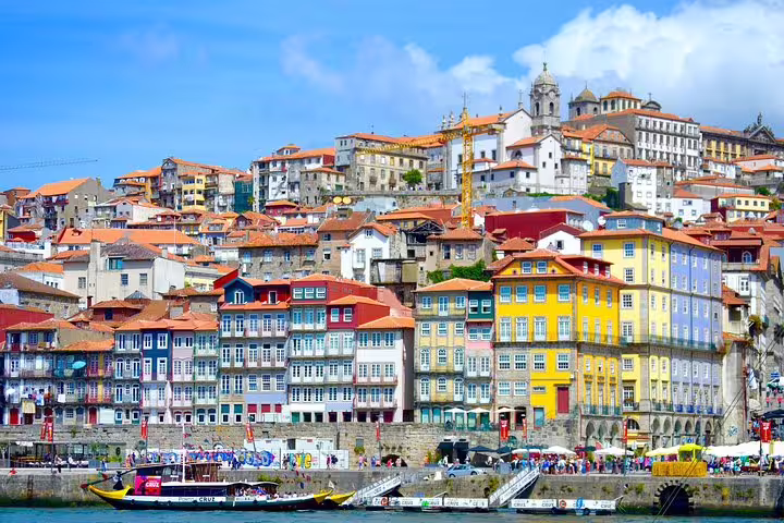 Colorful historic Ribeira district buildings along the Douro River in Porto, perfect for exploring on a half-day tour.