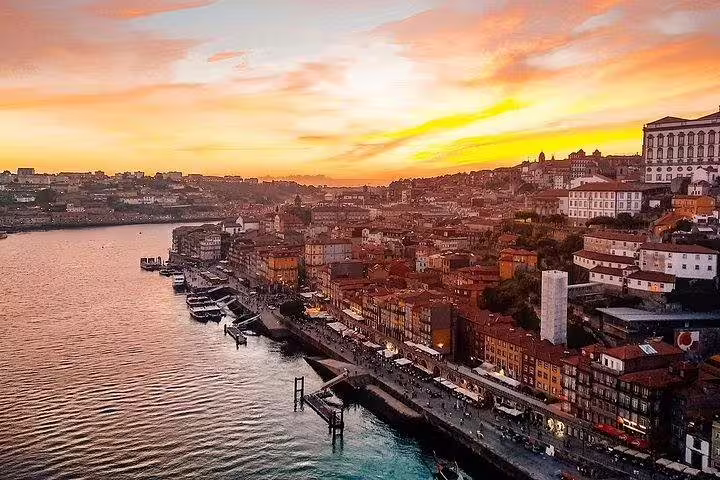 Scenic sunset view over Porto's historic Ribeira District along the Douro River, captured on a Lisbon to Porto day trip.