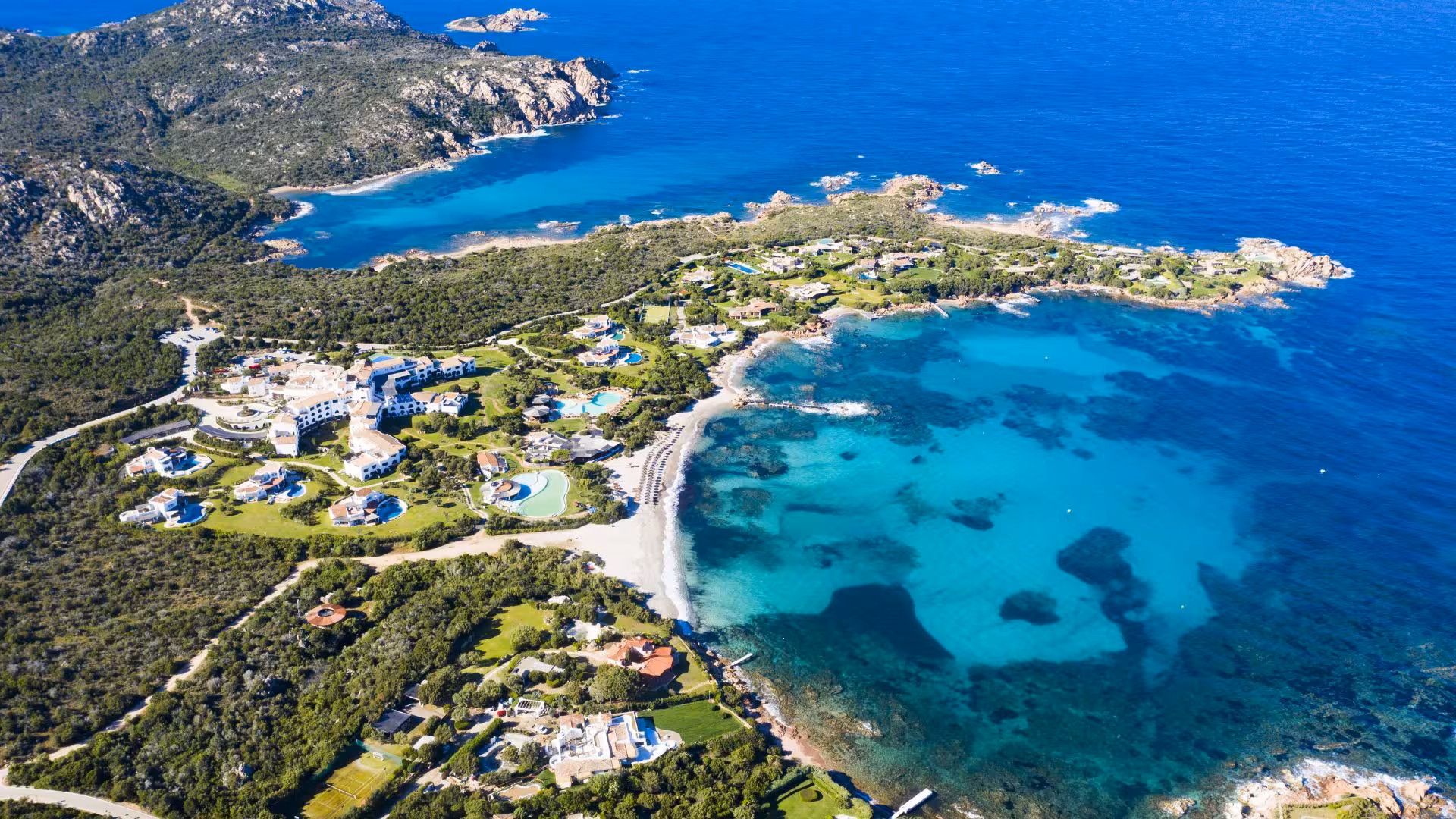 Aerial view of stunning blue bays and coastal villas in the La Maddalena Archipelago from Porto Rotondo dinghy tour.