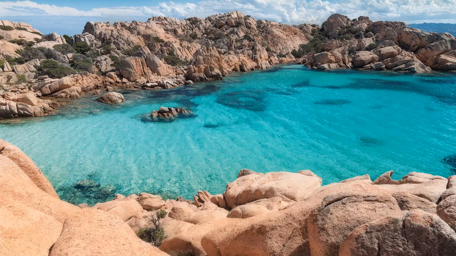 Crystal-clear turquoise waters and rugged cliffs in the La Maddalena Archipelago, perfect for a Porto Rotondo dinghy tour.