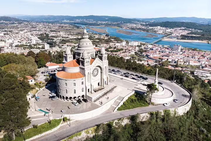 Aerial view of a majestic basilica overlooking the landscape on the Porto to Santiago Compostela tour route.