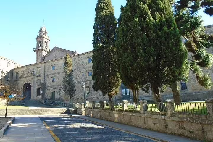 Historic stone monastery and bell tower near Santiago de Compostela, scenic highlight on private day trip from Porto