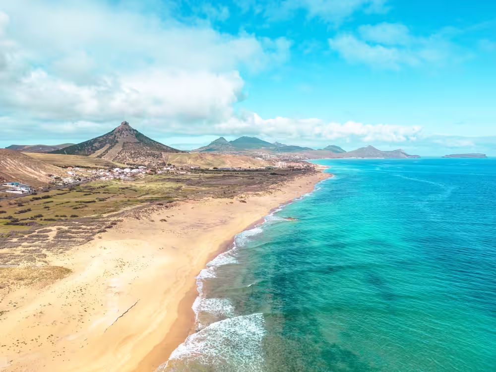 Aerial view of Porto Santo's golden sandy beach and turquoise waters, perfect for the Ocean Seeker experience.