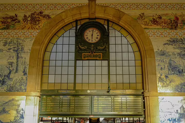 Admire the intricate tile work and historic clock at Porto's São Bento Railway Station on your private city tour.