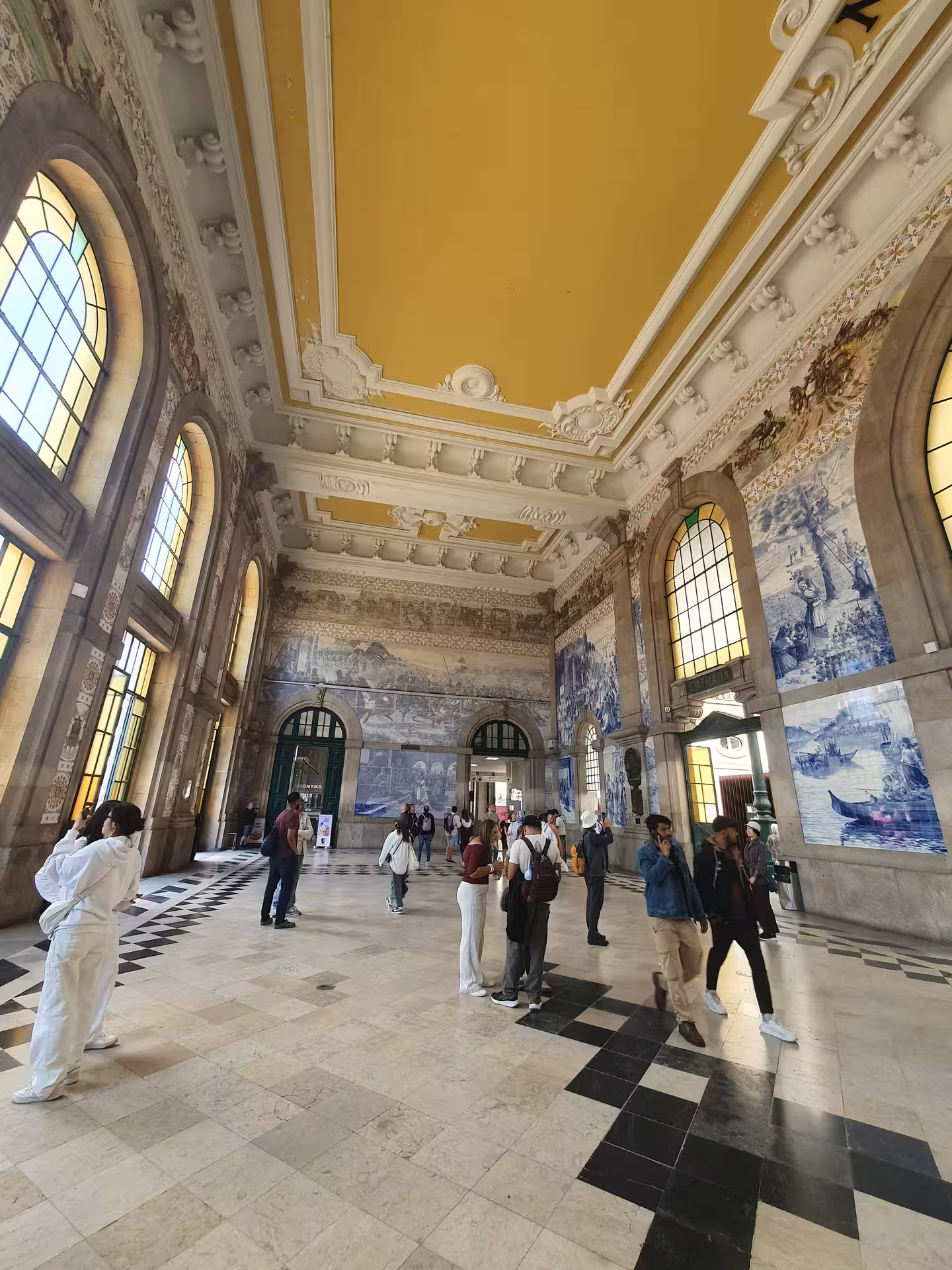 Visitors marvel at the ornate azulejo tiles inside São Bento Station, a highlight on the Porto to Gaia tour.
