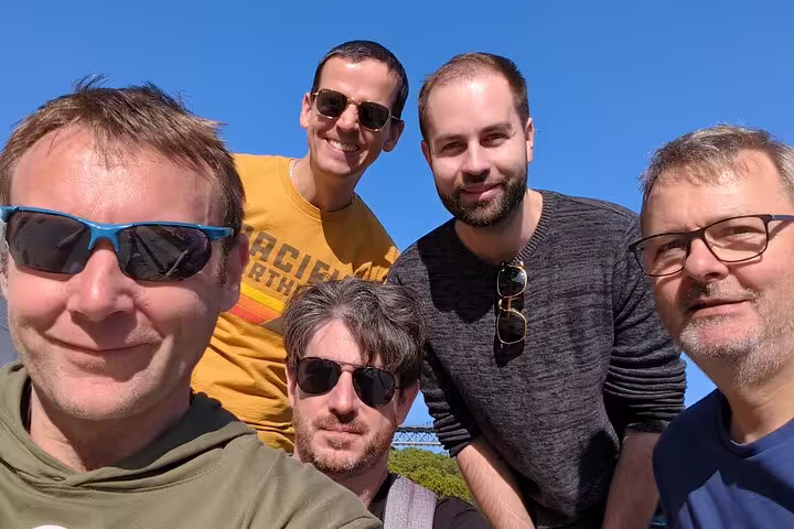 Group selfie in sunny Porto while exploring landmarks on a self-guided scavenger hunt and sights tour