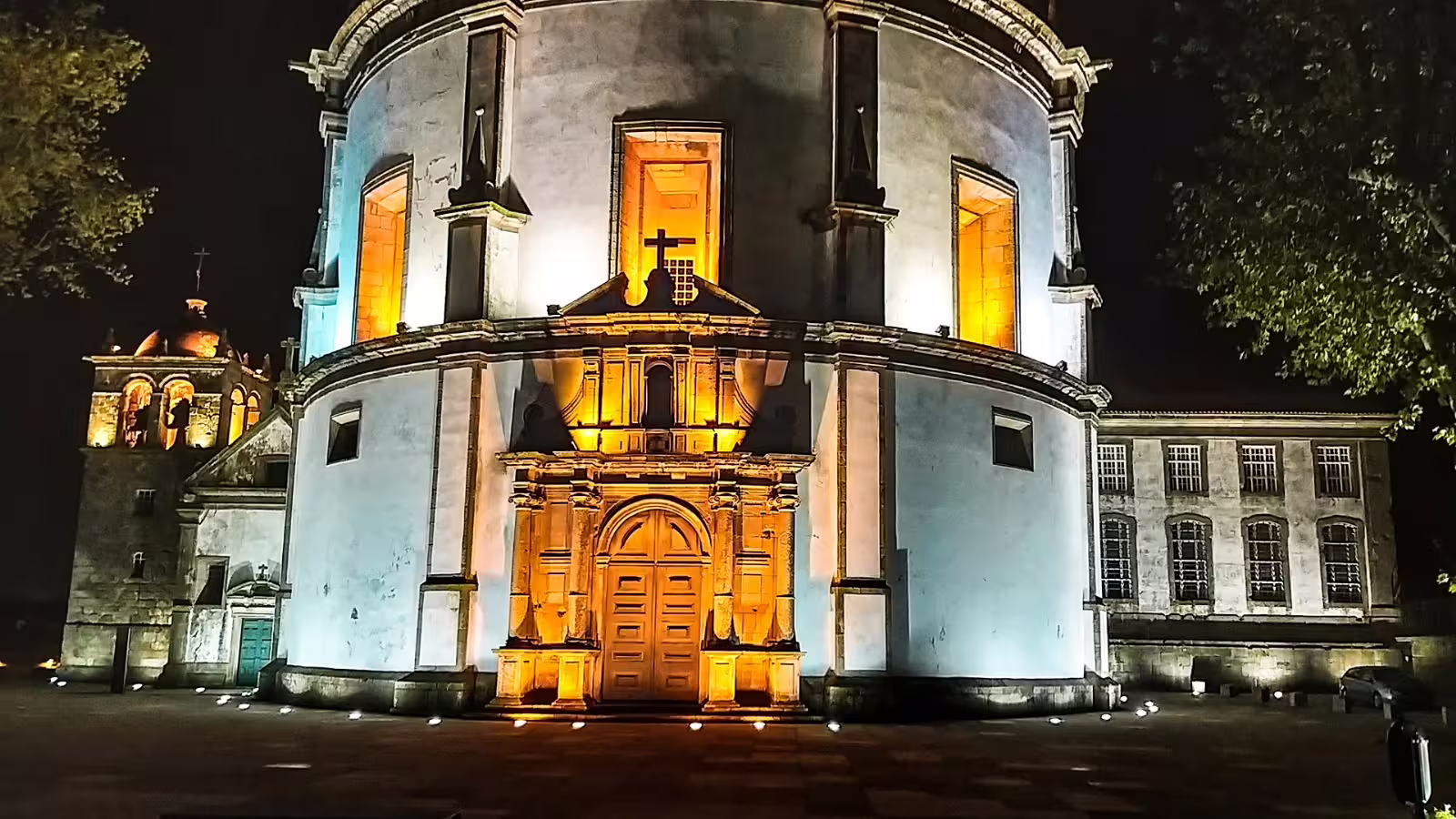 Illuminated night view of Porto's iconic Serra do Pilar Monastery, showcasing its stunning architecture on a private night tour.