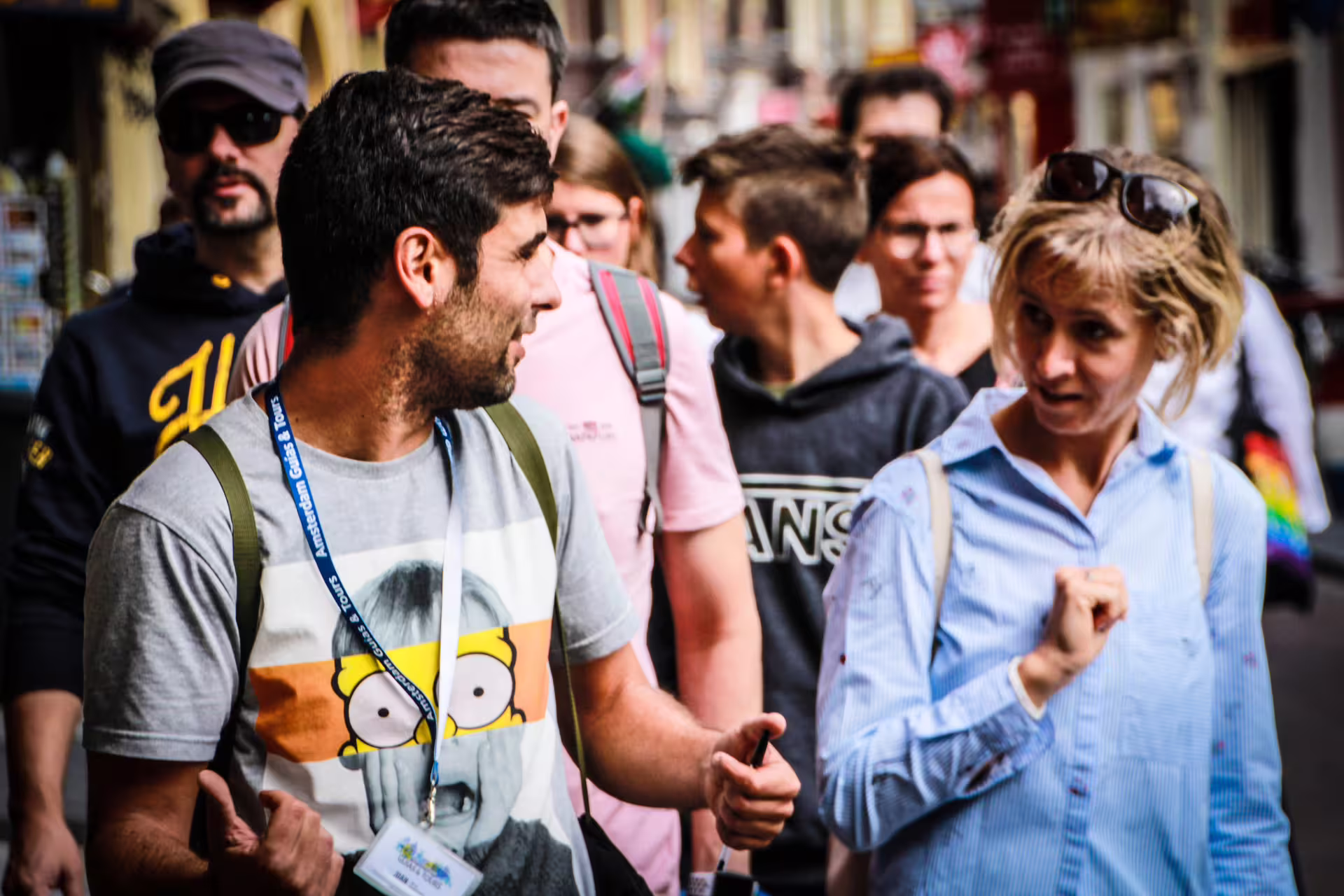 Group of tourists engaged in a lively conversation during a small-group walking tour in Porto's vibrant streets.