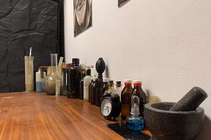 Porto tintype studio setup with vintage bottles and tools, 19th-century metal portrait workshop experience Portugal