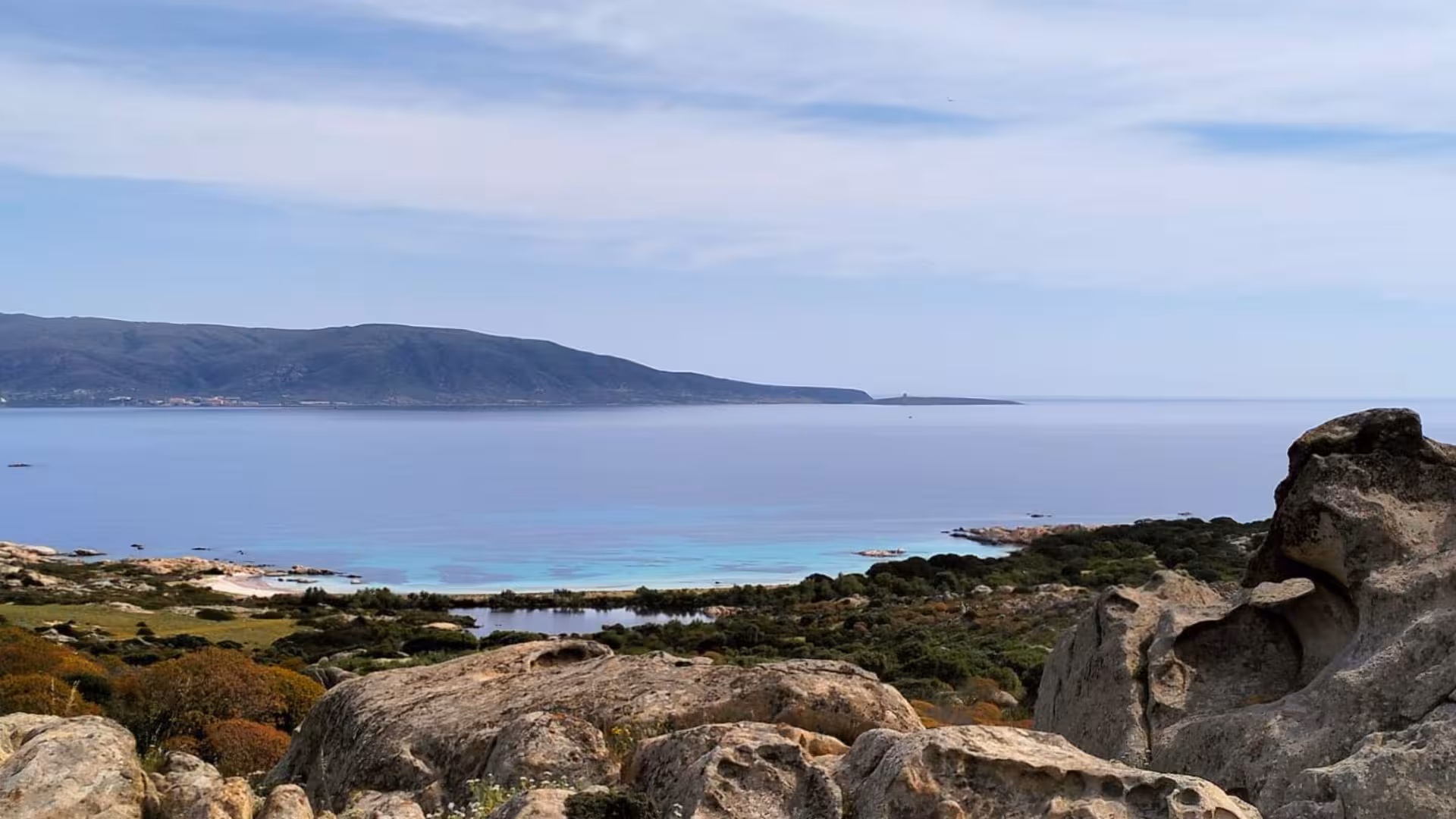 Breathtaking Asinara Island coastline with crystal-clear waters and rocky landscape, featured in Porto Torres tour.