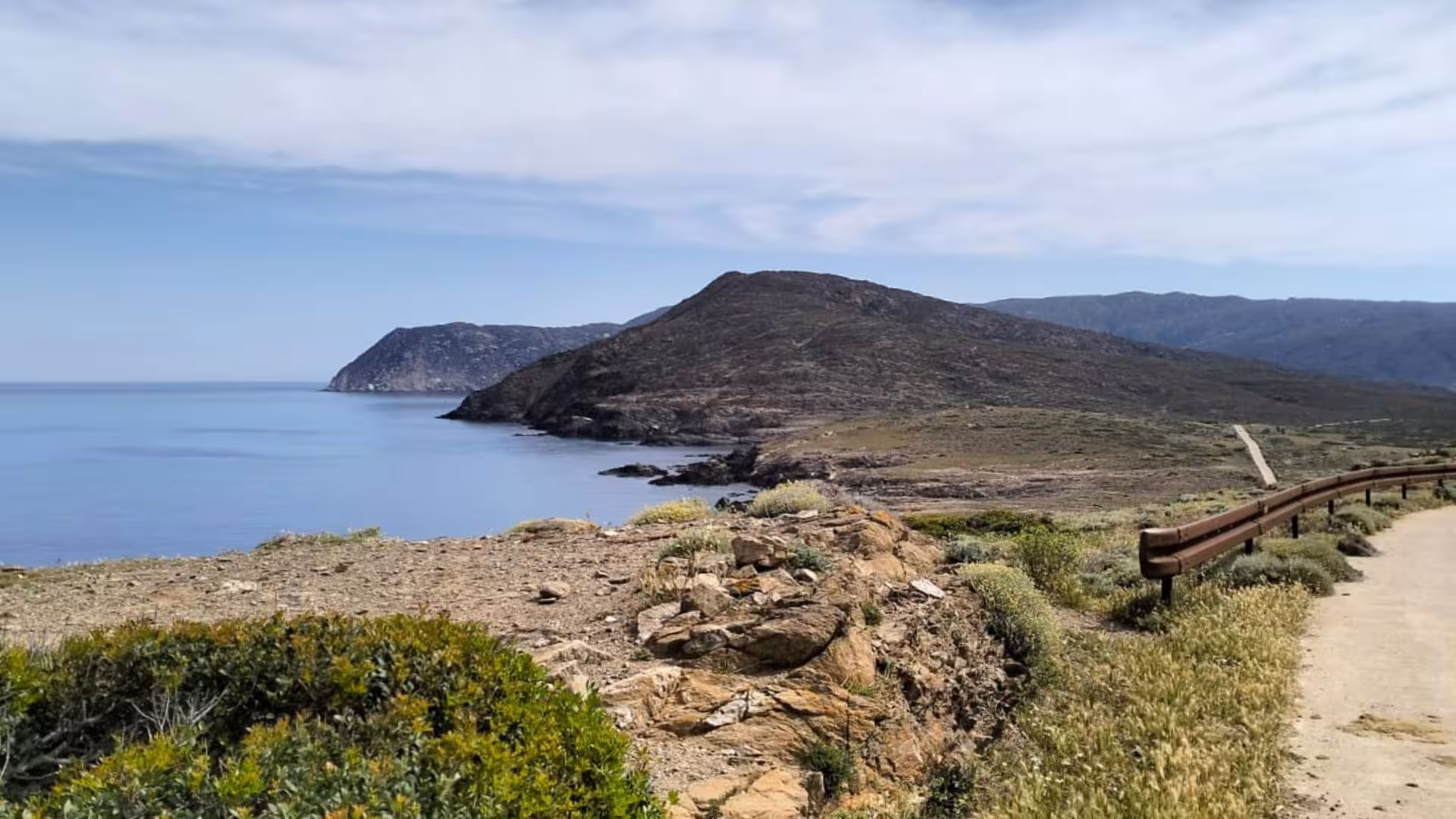 Scenic coastal view of Asinara Island with rugged cliffs and clear blue sea during a minivan tour from Porto Torres.