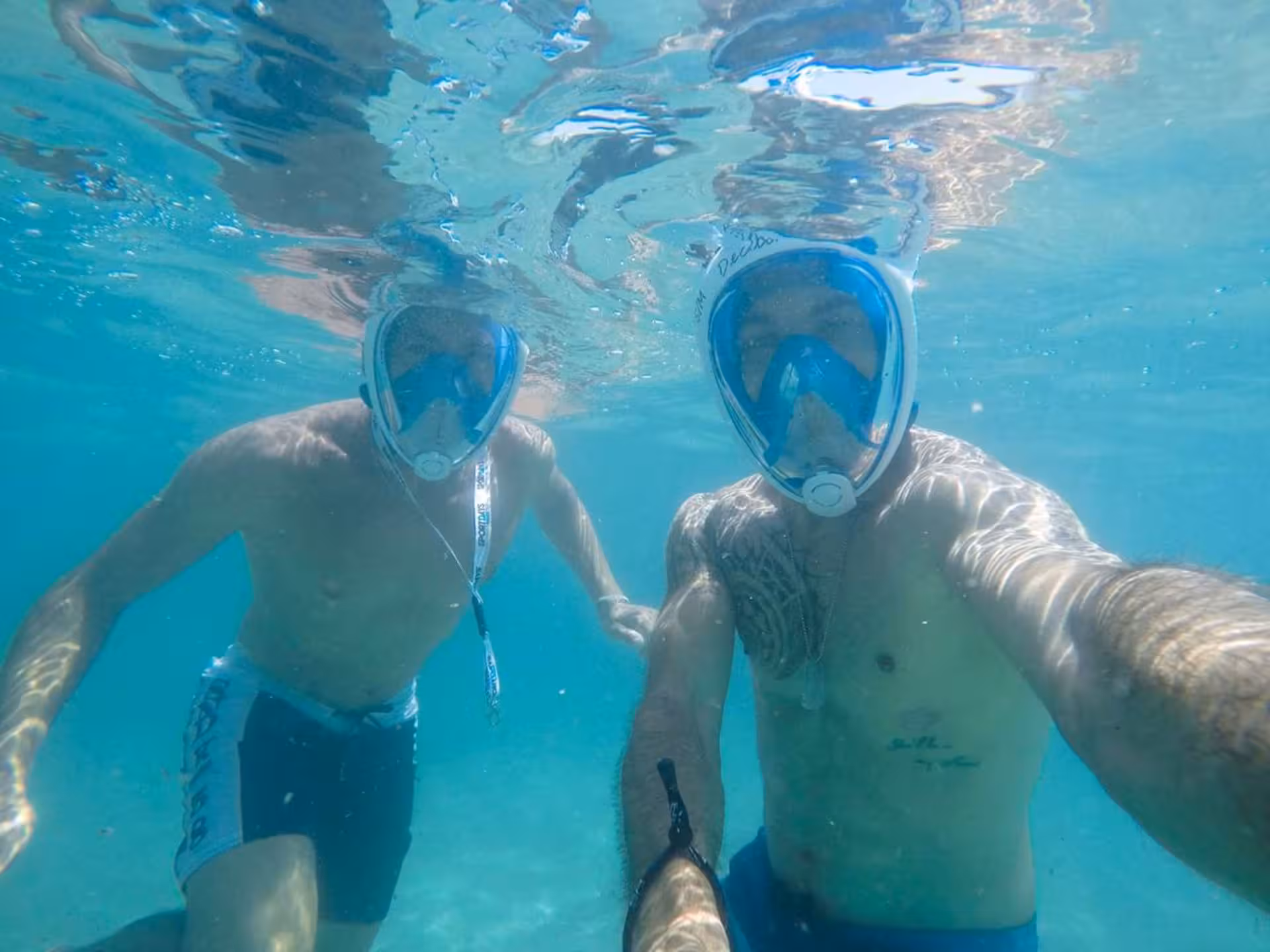 Two snorkelers enjoying the crystal-clear waters and marine life at Bay of Balai, Porto Torres.
