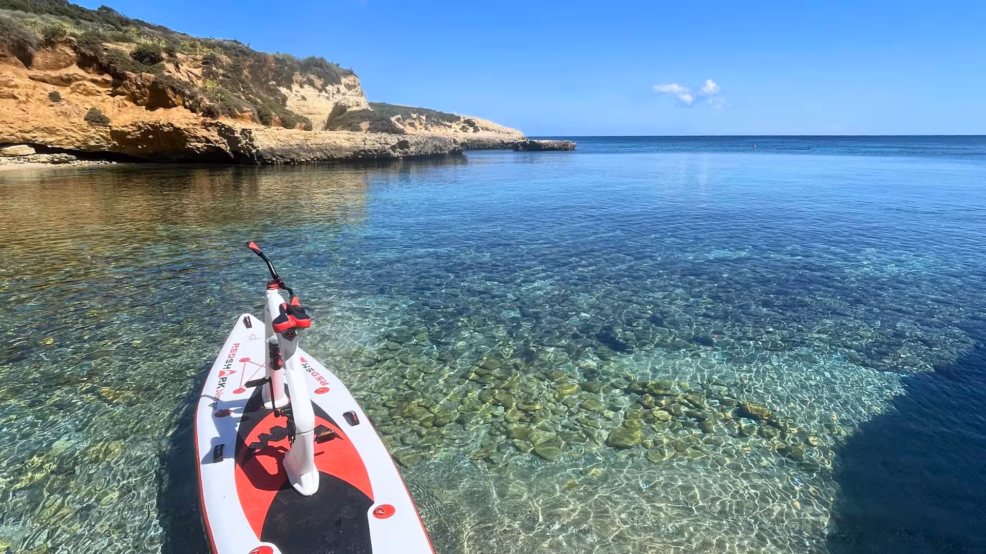 Discover crystal-clear waters of Porto Torres with a water bike adventure along rugged cliffs.