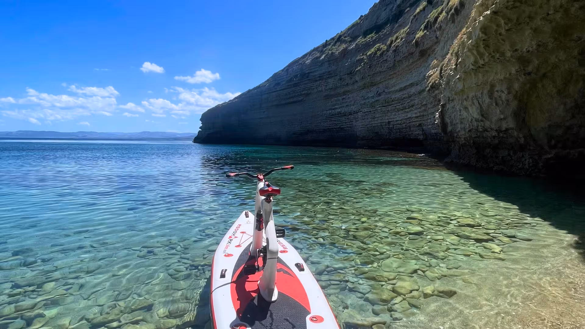 Experience Porto Torres' stunning coastline on a water bike, perfect for exploring serene, turquoise waters.