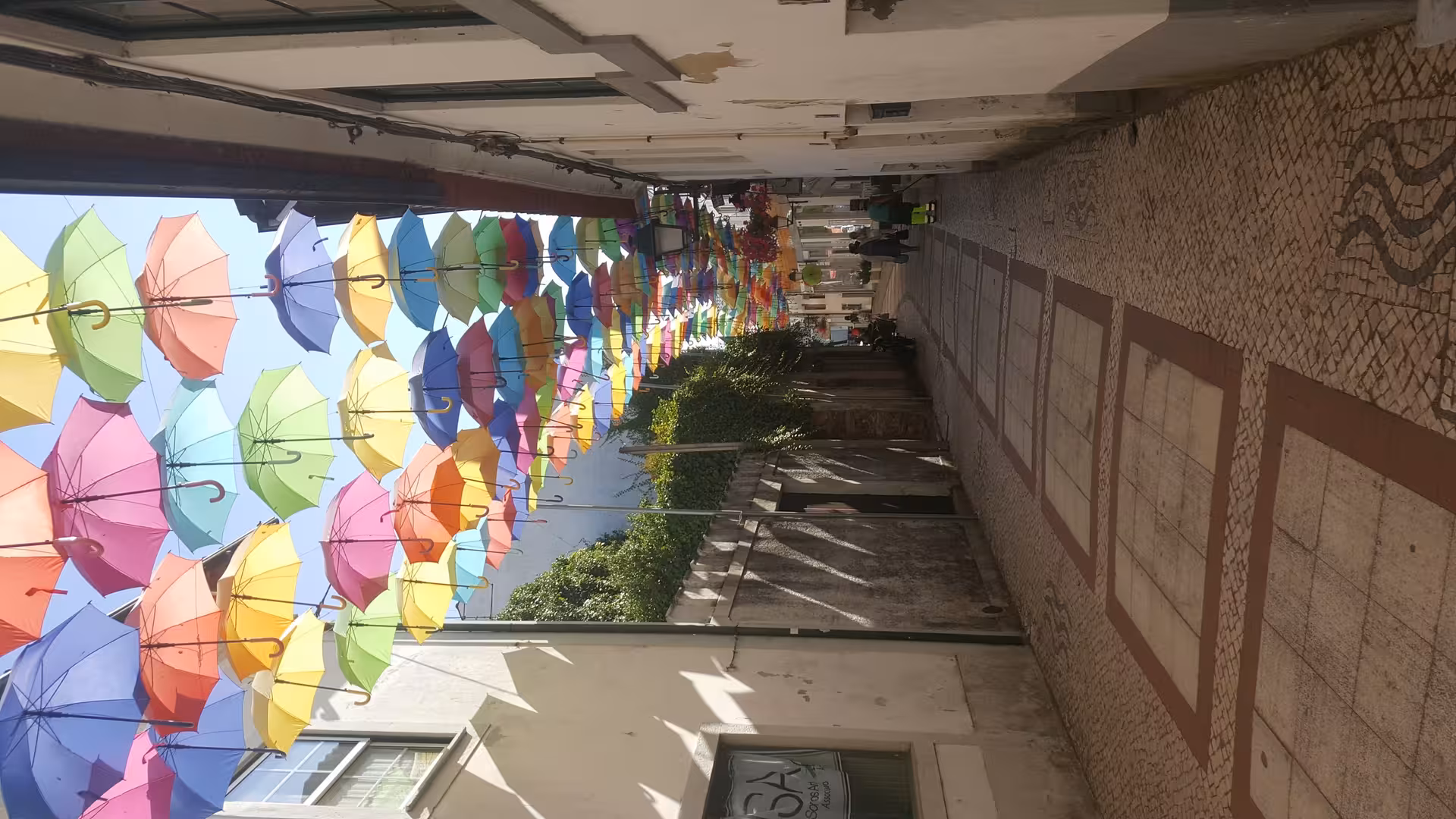 Colorful umbrella street in Águeda, comfortable Porto transfer service for day trips with easy pickup