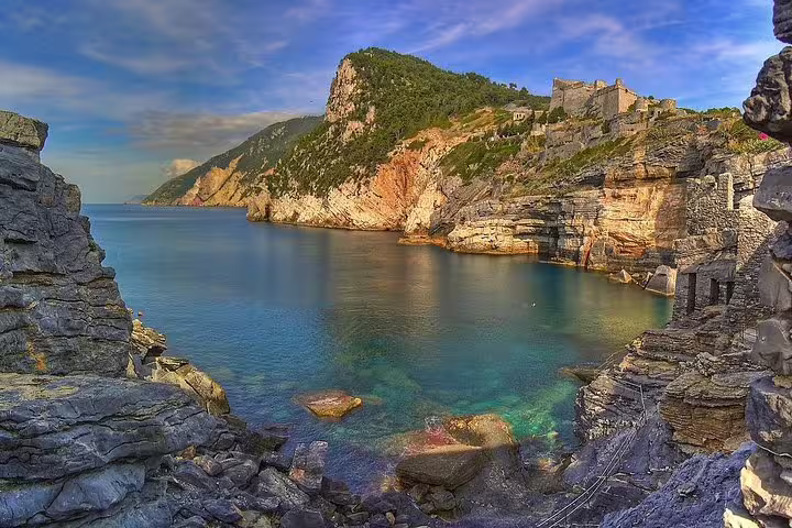 Crystal-clear bay and dramatic cliffs of Porto Venere, Italy, seen on a private Gulf of Poets coastal boat and walking tour