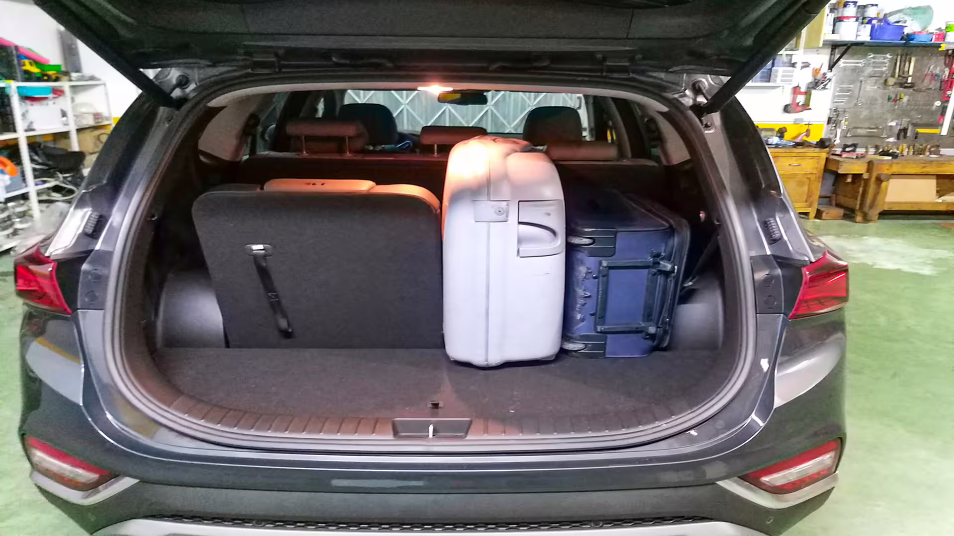 Car trunk with neatly packed suitcases for convenient Porto to Vieira do Minho transfer.