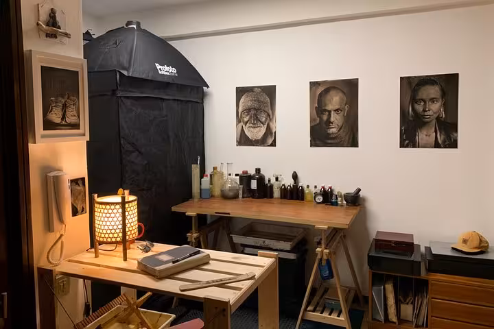 Porto wet plate studio workspace with chemicals and historic portraits, part of 19th-century metal photo tour
