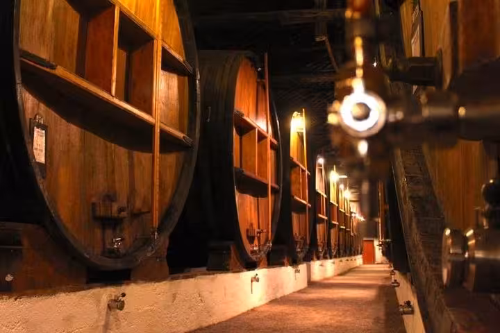 Explore Porto's traditional wine cellar with large wooden barrels on a private tour for 1 to 8 people.