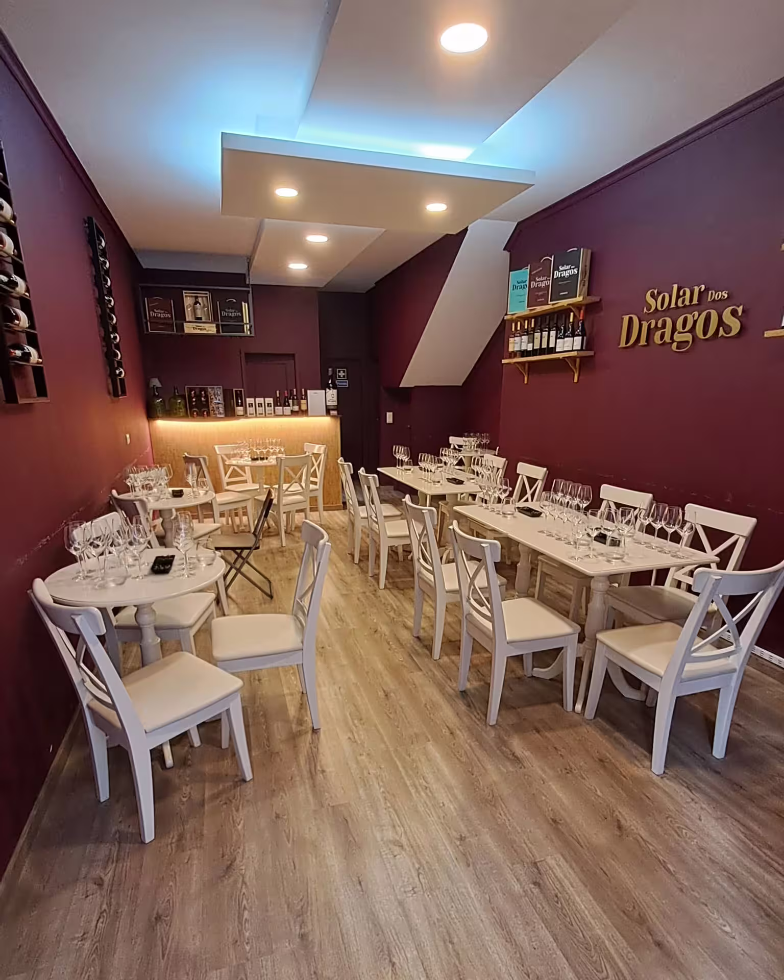 Elegant wine tasting room in Porto set for guests, featuring white chairs and tables with glasses ready for the tour.