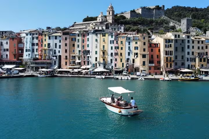 Charming Portovenere waterfront with vibrant buildings seen from a boat on the La Spezia island tour.