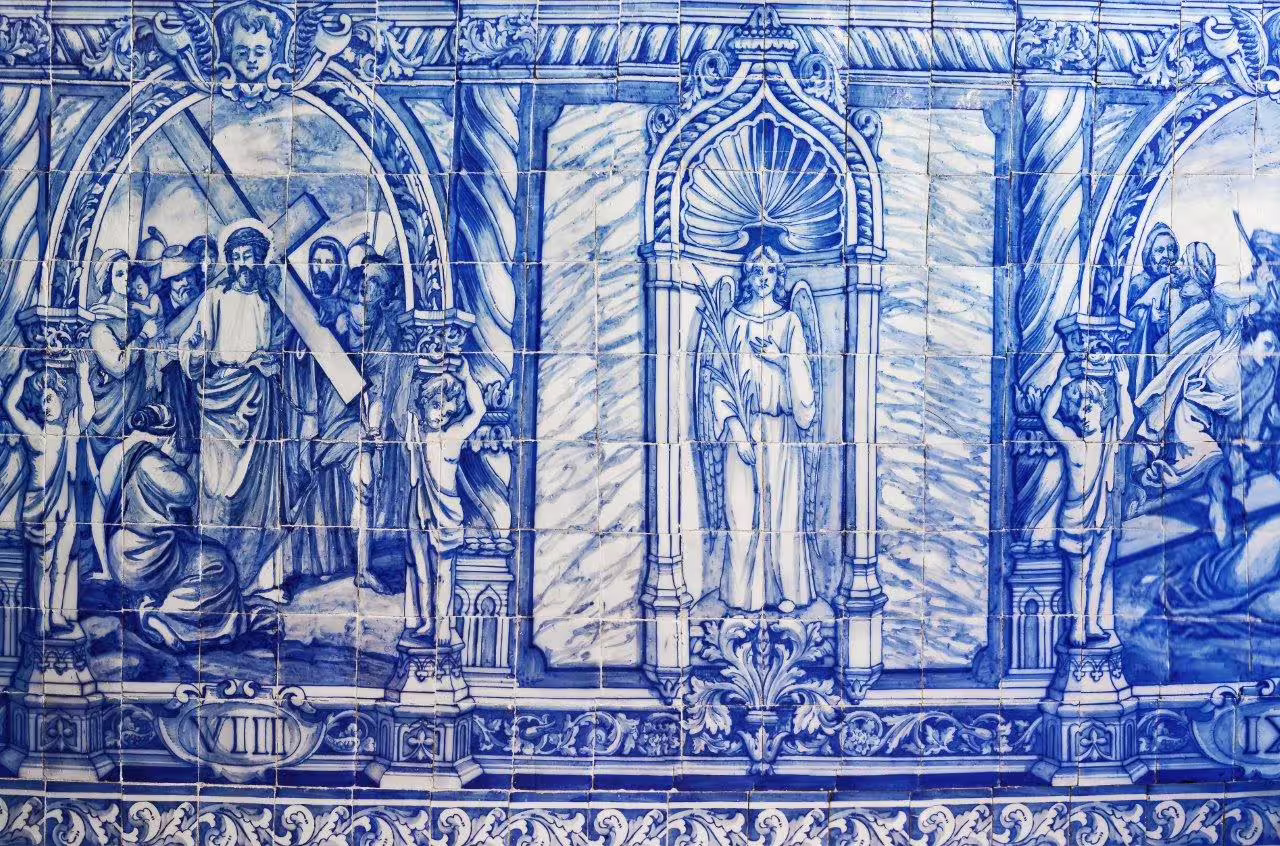 Intricate blue azulejo tiles depicting historical scenes, highlighting Portugal's rich cultural heritage on an inland self-drive tour.