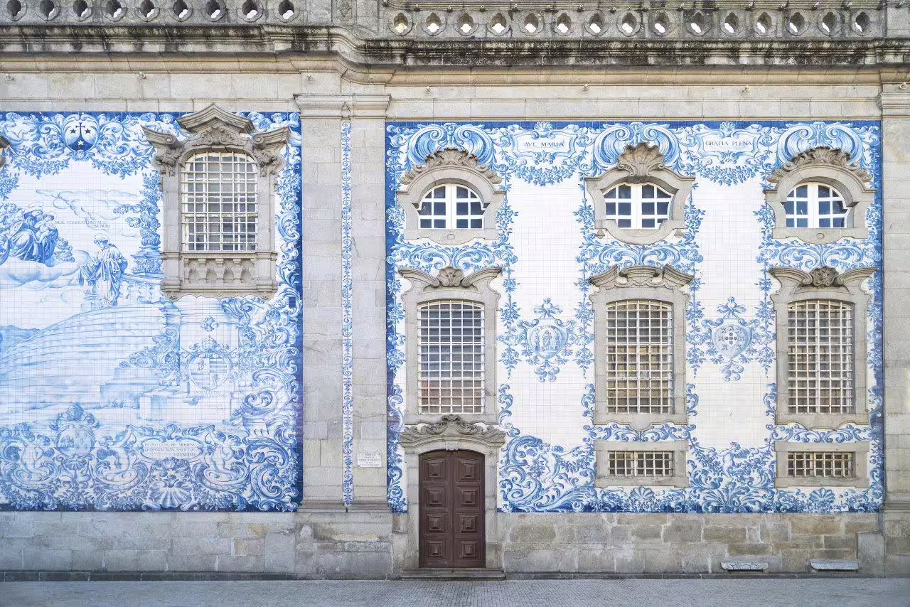 Historic Portuguese building facade adorned with intricate blue azulejos tiles, perfect for a self-drive Portugal discovery tour.