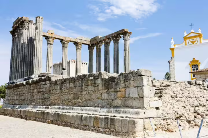 Ancient Roman Temple of Évora under a clear blue sky, showcasing Portugal's historic charm on a self-drive inland tour.