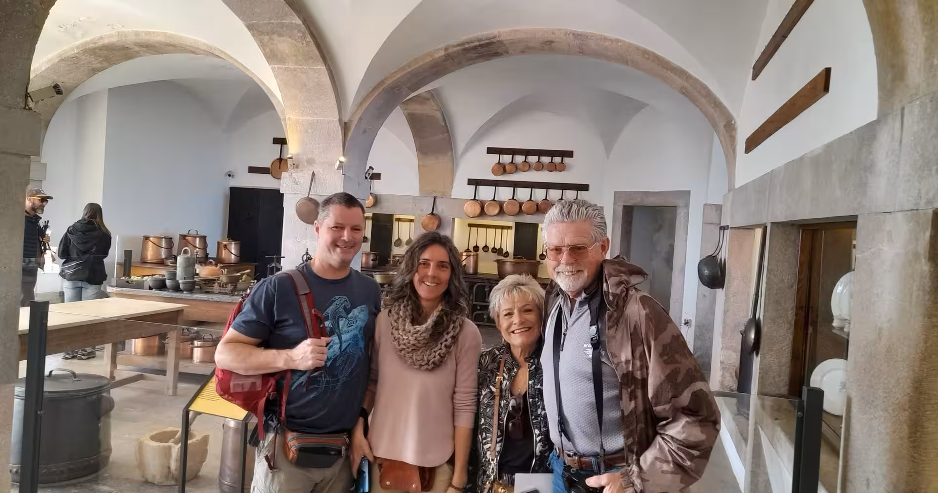 Group photo in a historic Portuguese kitchen during cooking class, part of 8-day Portugal food and wine tour
