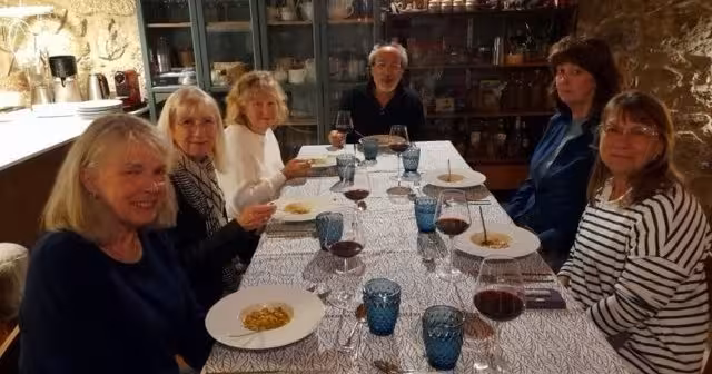 Small group enjoying Portuguese dinner and red wine tasting during 8-day Portugal food and wine tour