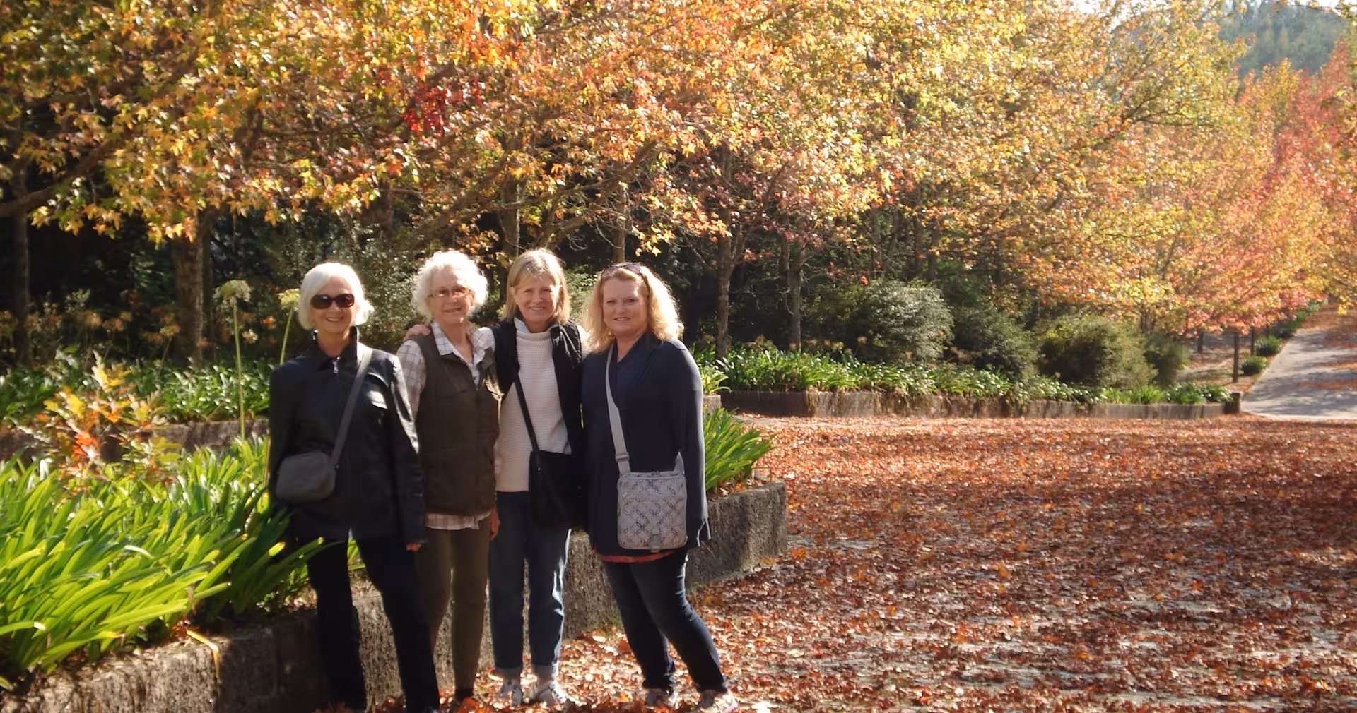 Guests strolling a scenic garden in autumn on 7-day Portugal tour from Lisbon to Porto and Douro Valley