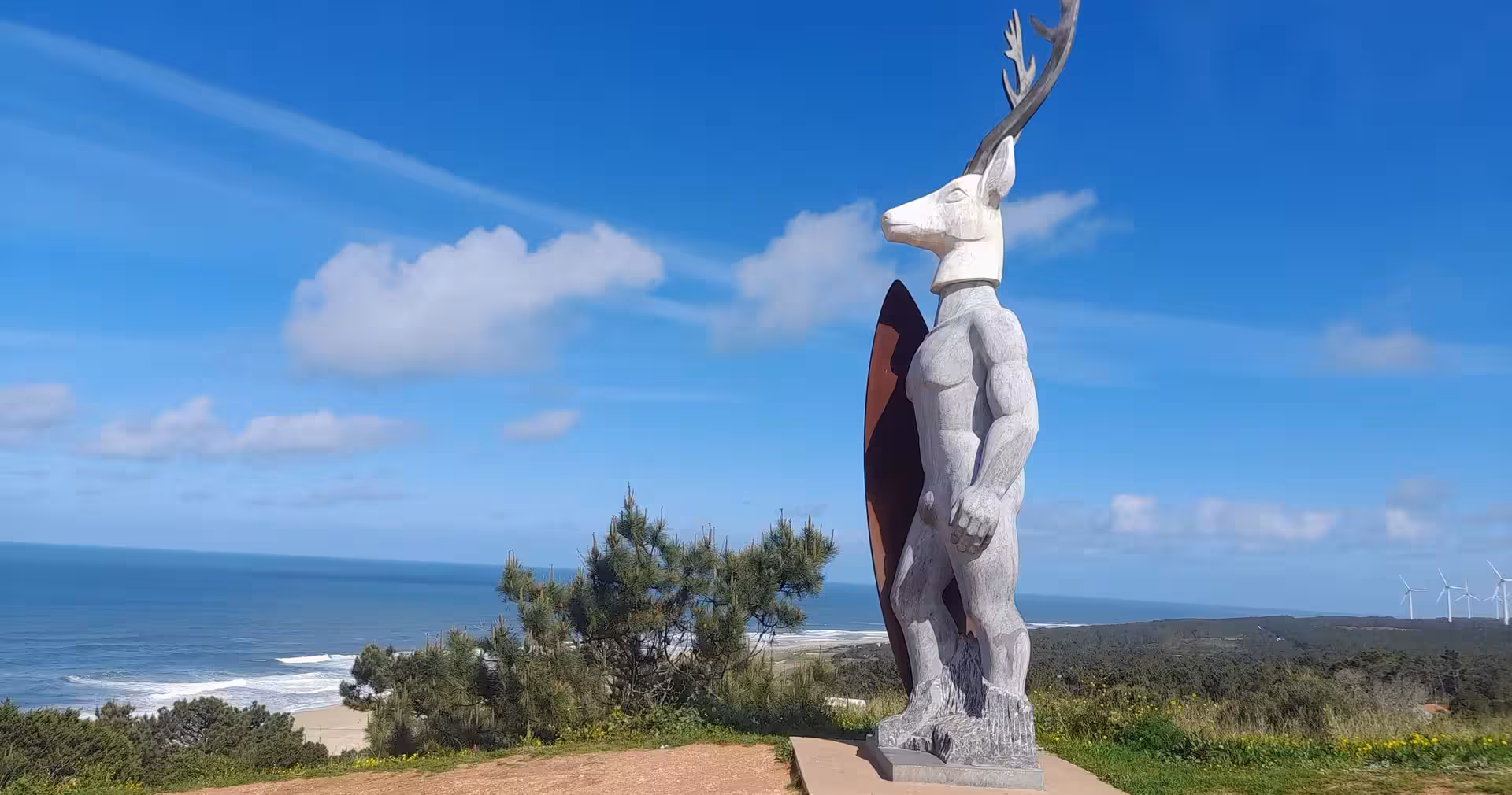Coastal viewpoint statue overlooking Atlantic near Nazaré, scenic stop on 7-day Portugal tour from Lisbon to Porto