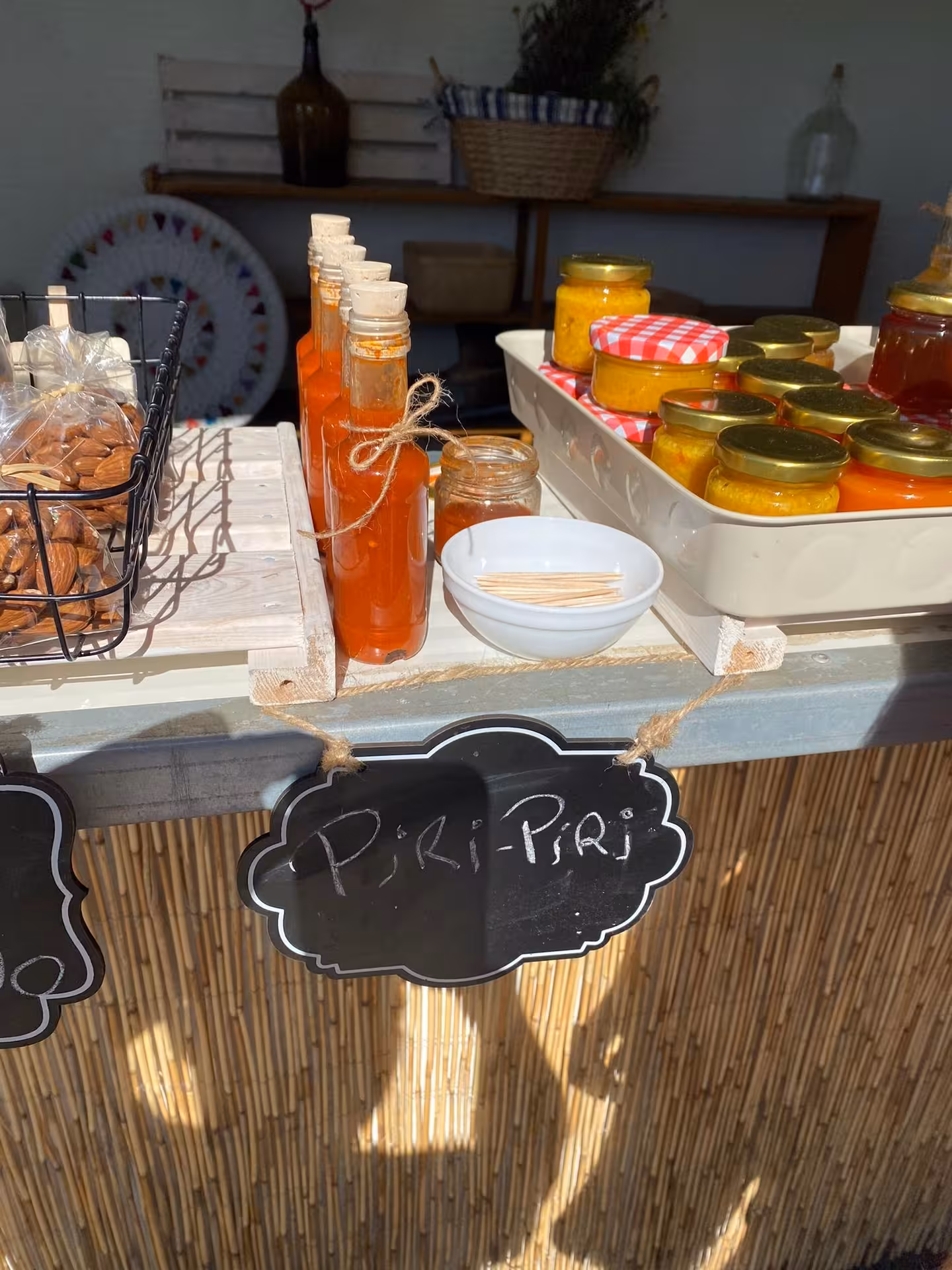 Local piri-piri sauce and homemade preserves displayed at a rustic tasting stall on a half day wine tour in Portugal