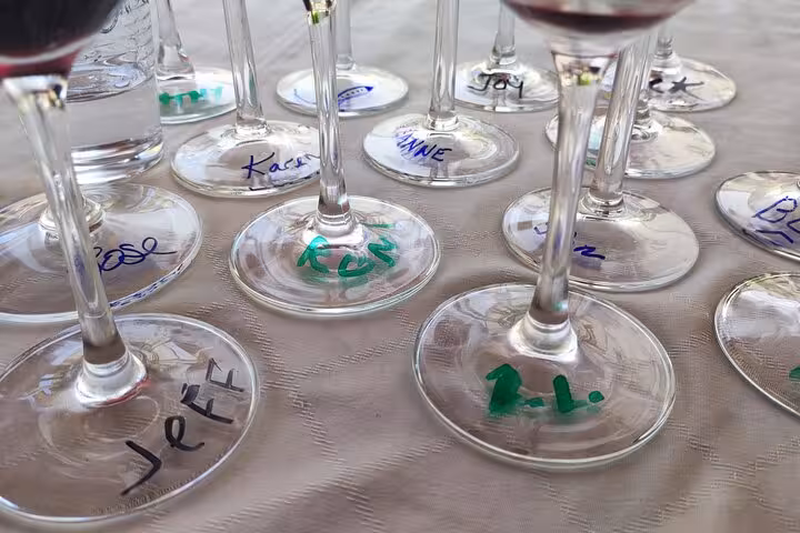 Wine glasses with personalized names await participants at the Portuguese cuisine cooking class on the terrace.