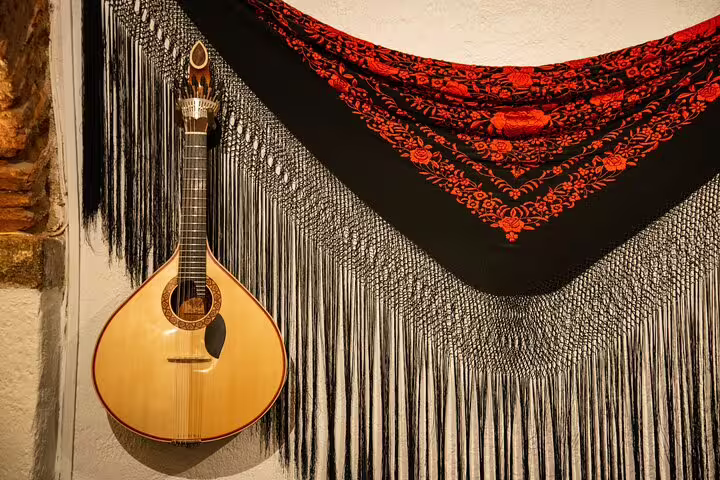 Portuguese guitar and traditional shawl evoke Lisbon's rich history and fado music, perfect for cultural discovery tours.