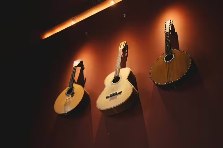Trio of traditional Portuguese guitars on display at Mesa de Frades, setting the stage for an authentic Fado show.