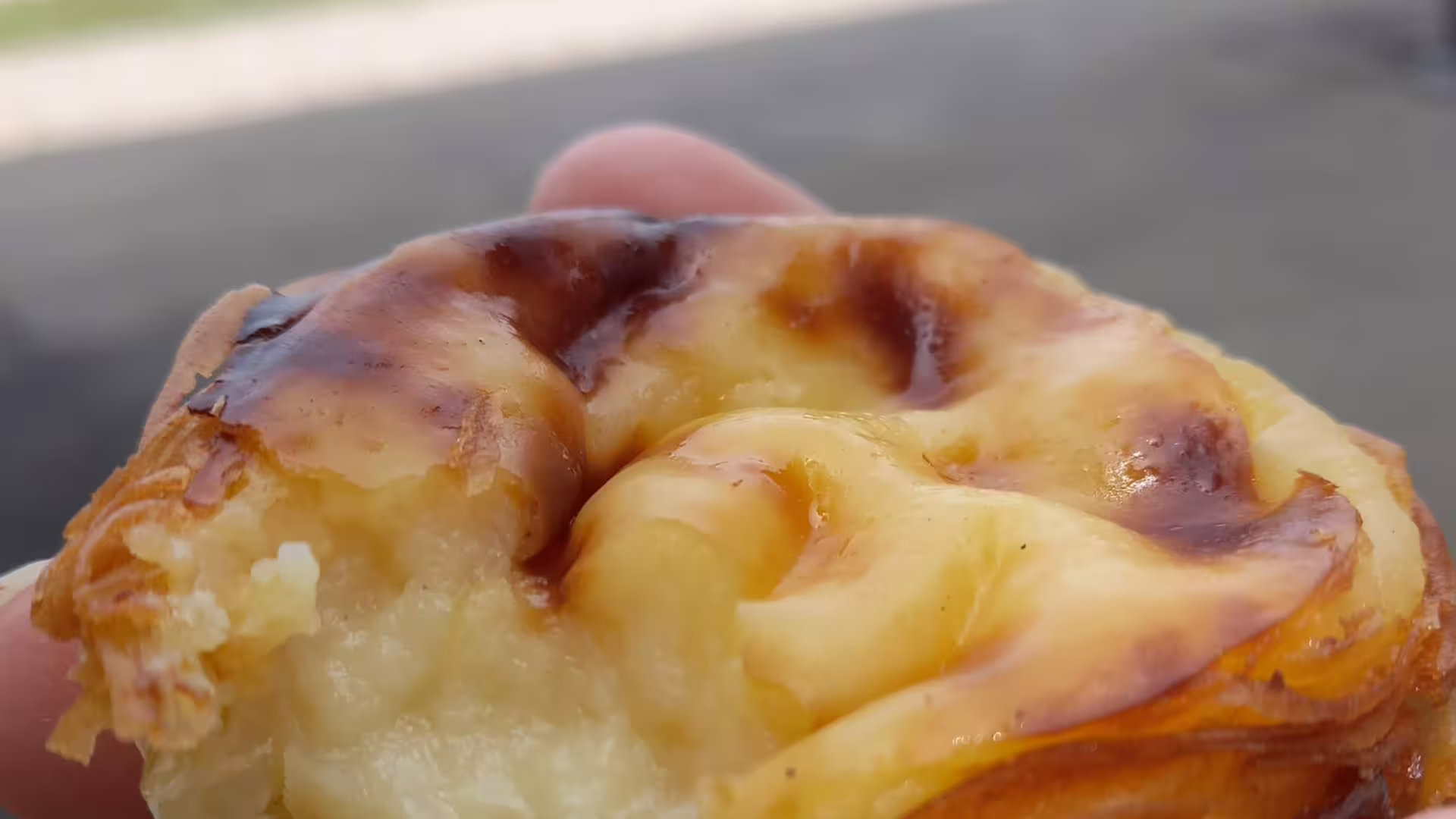 Close-up of a traditional Portuguese pastel de nata enjoyed on the Belem Coast Road tour from Lisbon to Sintra.