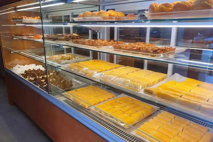 A display of traditional Portuguese pastries in Azeitão, featuring an array of sweets and baked goods on the Arrábida tour.