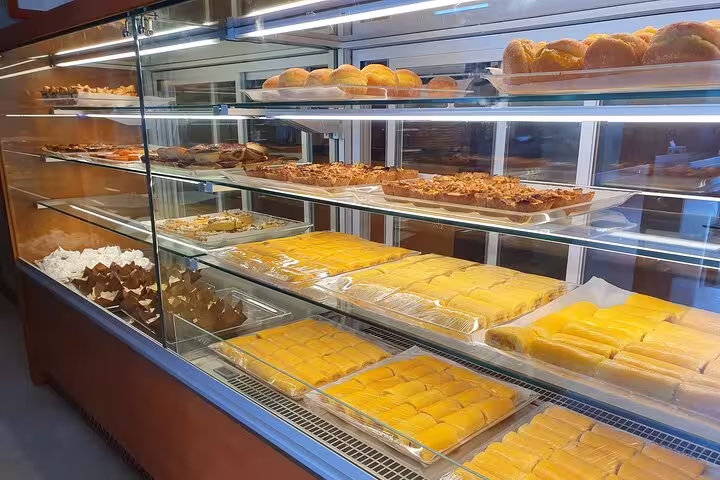 Display of traditional Portuguese pastries in a bakery in Azeitão, showcasing the local culinary delights on the tour.