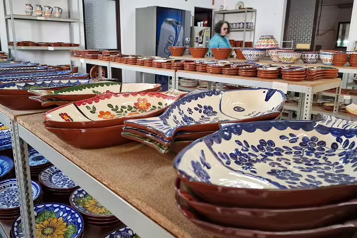 Colorful Portuguese pottery on display in a shop during a day trip from Lisbon to Évora and Monsaraz, showcasing artisanal crafts.