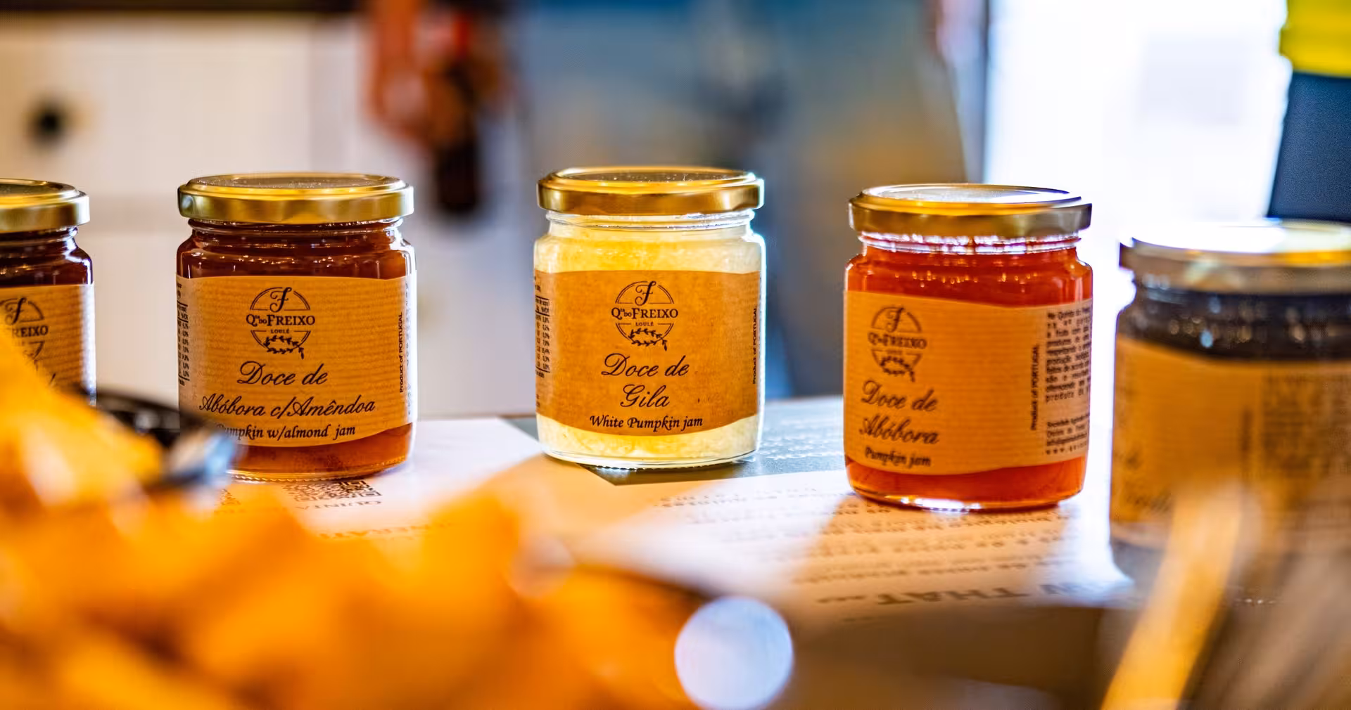 Artisanal Portuguese pumpkin jams displayed for tasting at a rural Algarve winery on The Wine & Nature Escape