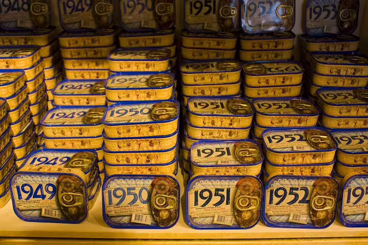 Vintage Portuguese sardine tins displayed on shelves, highlighting Lisbon's culinary heritage on a food and drink tour.