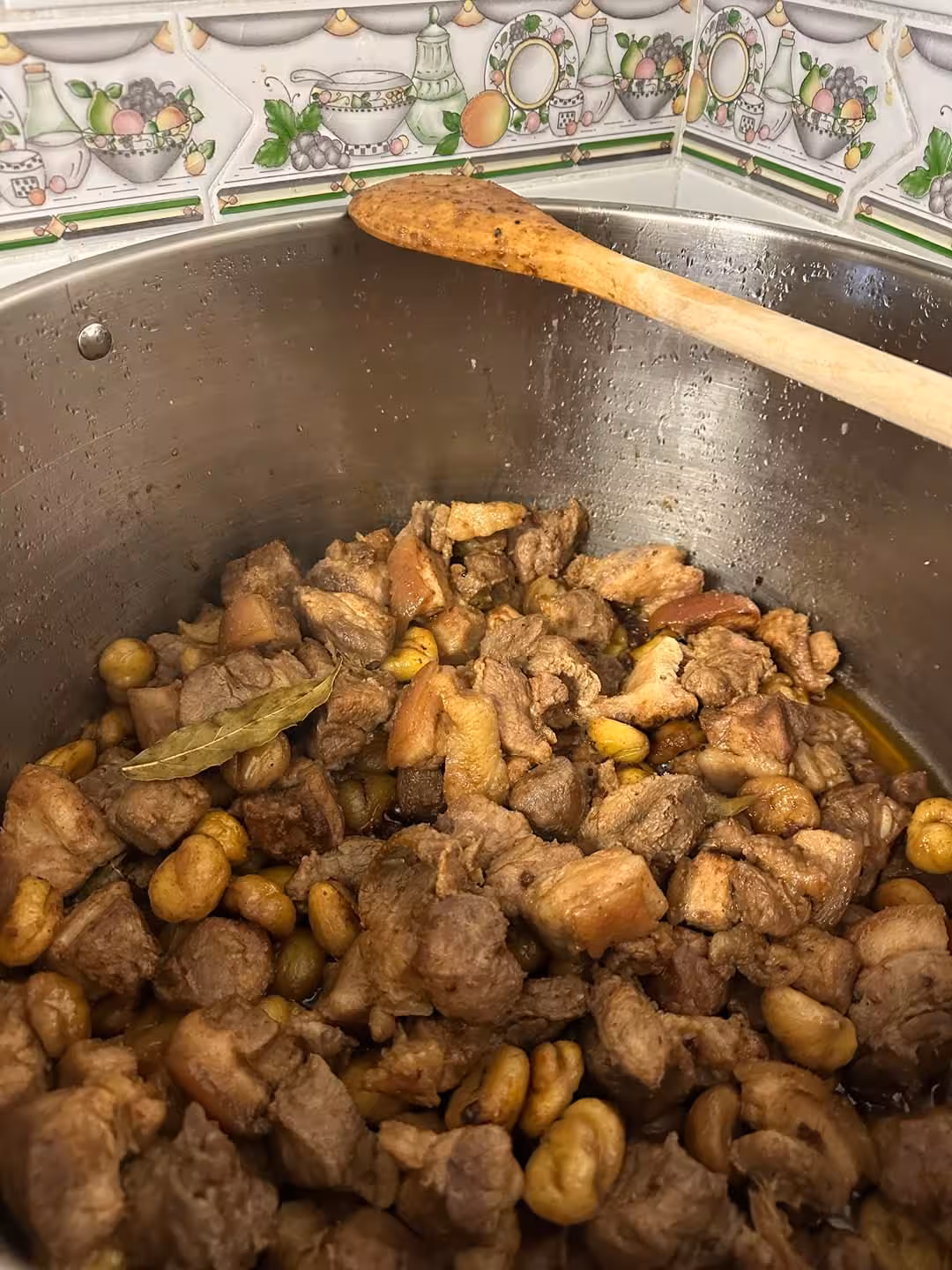 Traditional Portuguese stew simmering with beans and meat in a silver pot during Porto cooking class.