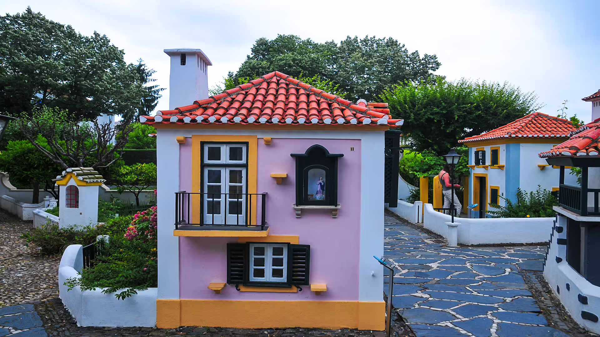 Charming colorful miniature houses in a quaint village setting, showcasing Portuguese architecture near Coimbra University tour.