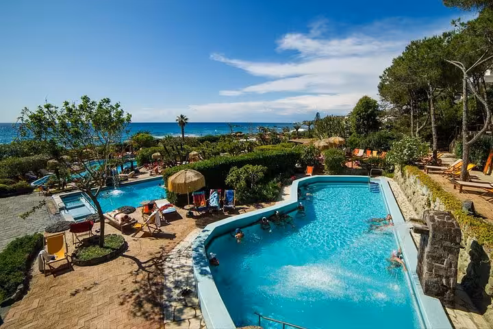 Relaxing pools and lush gardens at Poseidon Gardens, Ischia, offering a serene escape from Naples with coastal views.