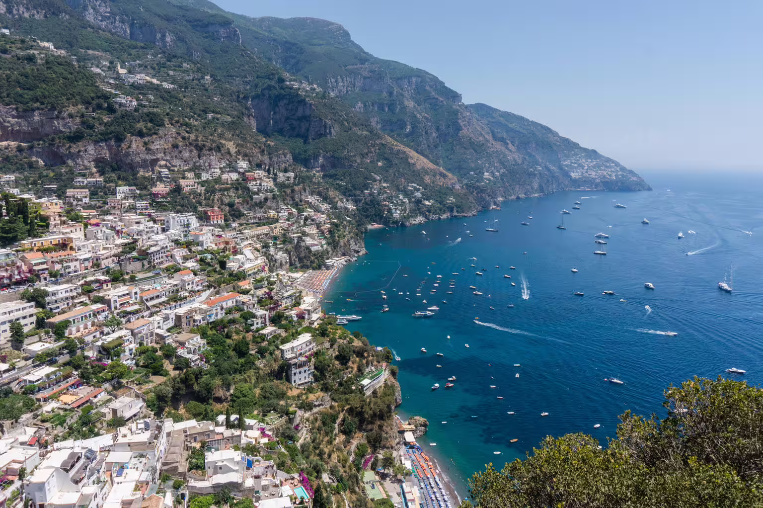 Panoramic Positano coastline with boats on Tyrrhenian Sea, scenic Amalfi Coast day trip from Naples