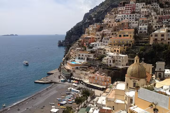 Stunning view of Positano's colorful cliffside buildings and beach, a highlight of the Naples to Amalfi tour.