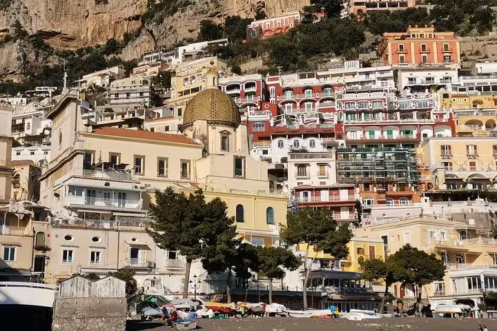 Vibrant hillside view of Positano's colorful buildings on the Amalfi Coast, perfect for a day trip from Rome.