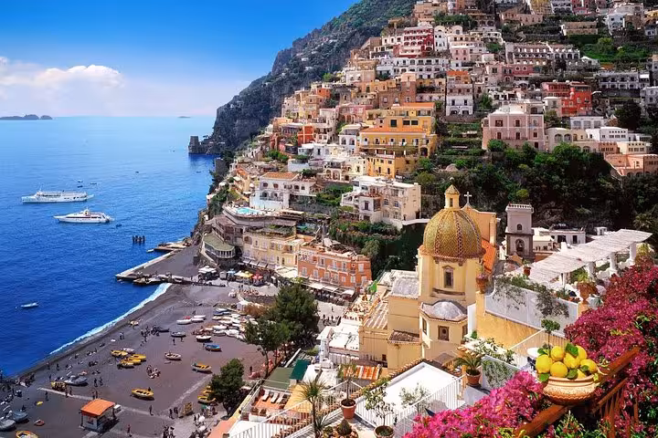 Stunning view of colorful Positano houses cascading down the cliffs to the Amalfi Coastline.