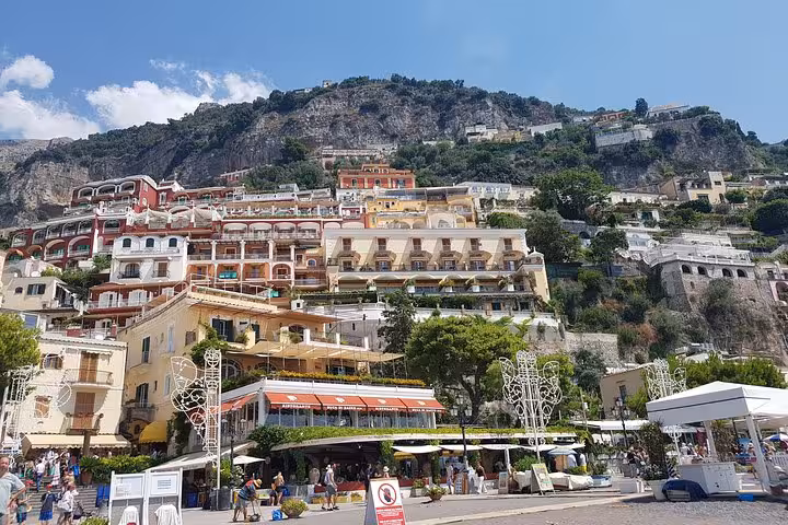 Positano hillside pastel hotels and lively piazza on Amalfi Coast day tour from Rome, Sorrento and Positano